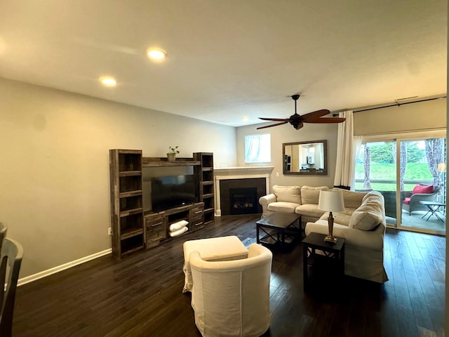 living area featuring recessed lighting, a fireplace, dark wood-type flooring, a ceiling fan, and baseboards