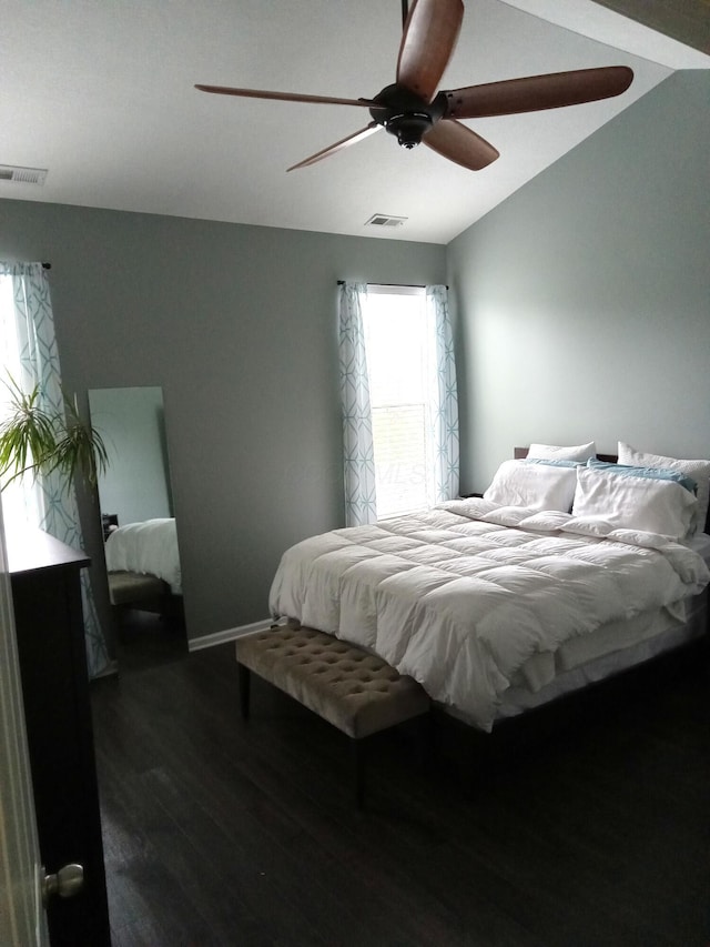 bedroom featuring dark wood-style floors, a ceiling fan, visible vents, and baseboards