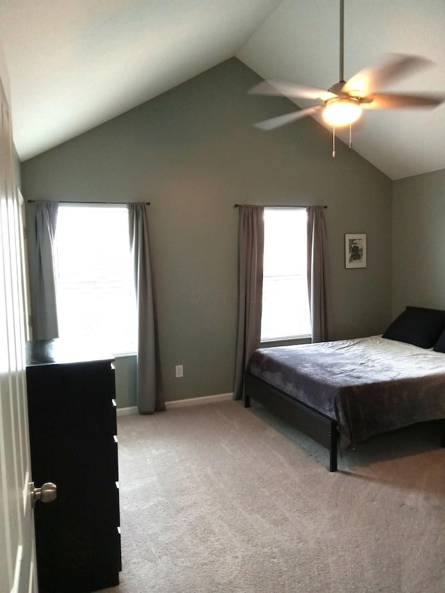 carpeted bedroom with baseboards, ceiling fan, and vaulted ceiling