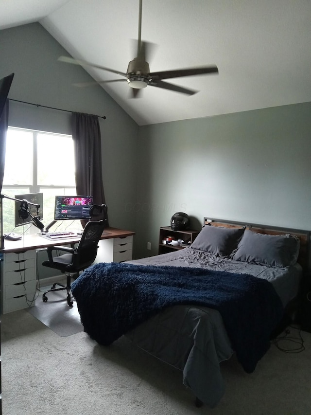 bedroom with ceiling fan, carpet floors, and vaulted ceiling