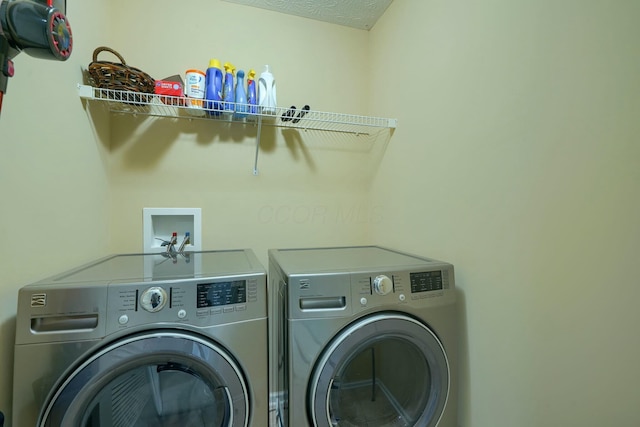 laundry area featuring washing machine and clothes dryer and laundry area