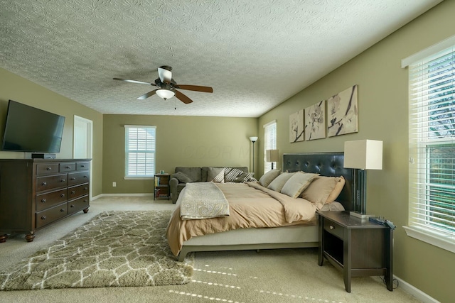 bedroom with baseboards, a ceiling fan, and multiple windows