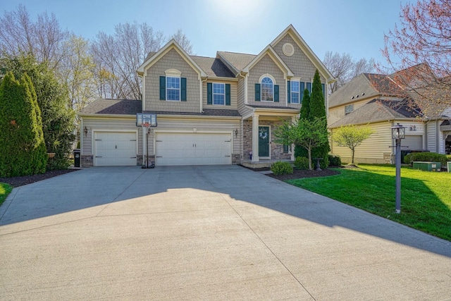 view of front of house with stone siding, an attached garage, a front yard, and concrete driveway