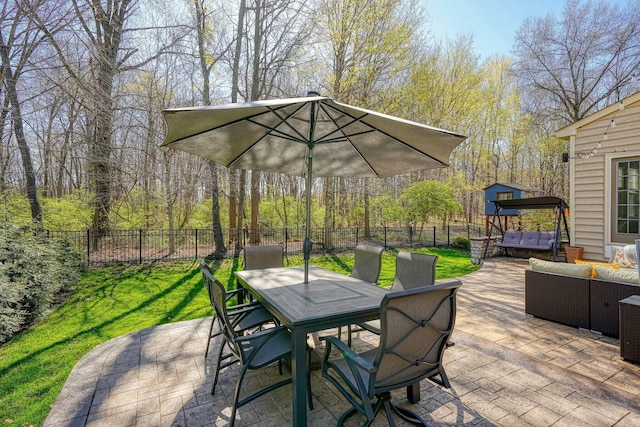 view of patio / terrace with an outdoor living space, a fenced backyard, and outdoor dining area
