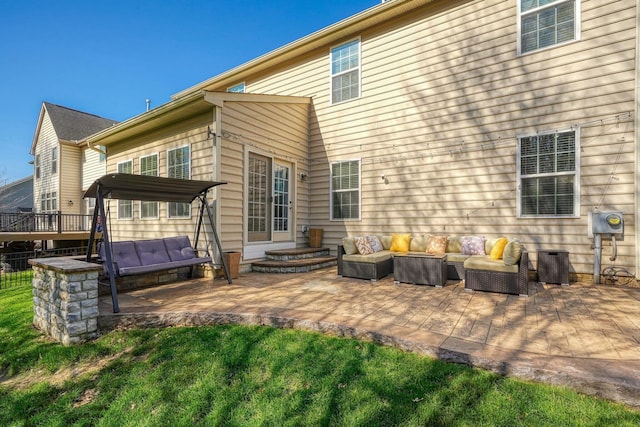 rear view of property featuring an outdoor living space, a yard, and a patio