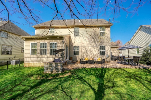 back of property featuring fence, a patio area, and a yard