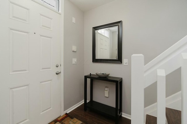 entrance foyer featuring baseboards and dark wood-style flooring