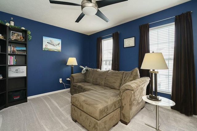 carpeted living room with ceiling fan, baseboards, and plenty of natural light