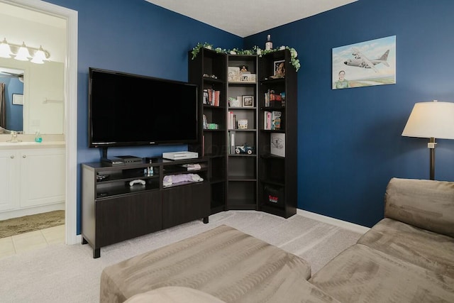 living area featuring baseboards and carpet flooring