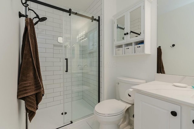 bathroom with vanity, toilet, and a stall shower