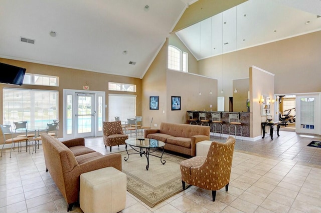 living room with high vaulted ceiling, baseboards, light tile patterned flooring, and visible vents