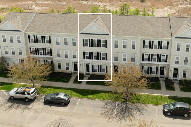 view of building exterior with uncovered parking
