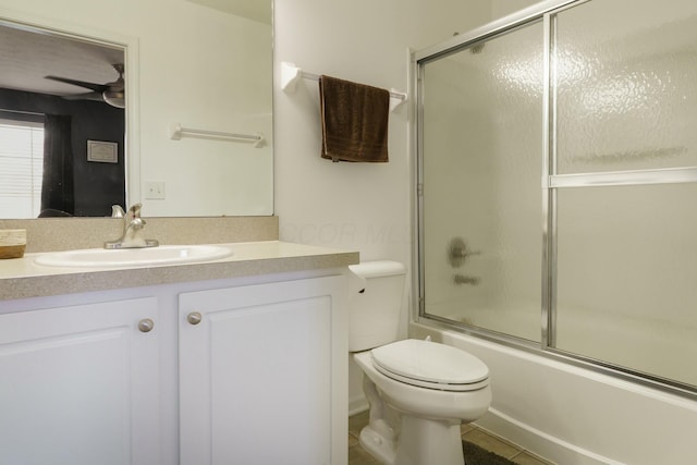 full bathroom with vanity, toilet, bath / shower combo with glass door, and a ceiling fan