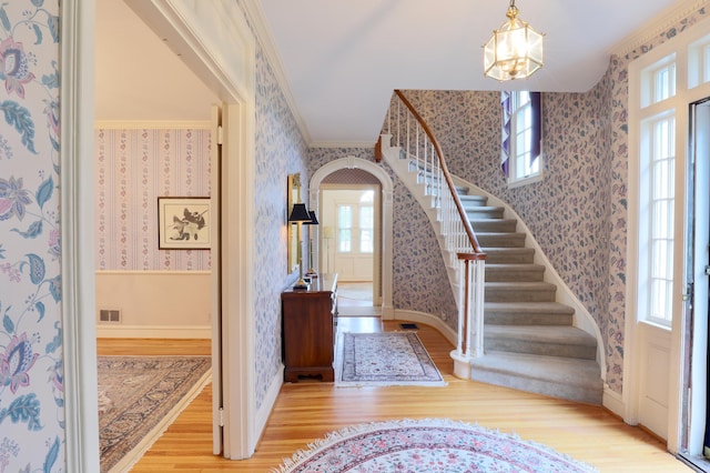536 E Allen St, Lancaster, OH 43130 - foyer with stairway, wallpapered walls, wood finished floors, and a notable chandelier
