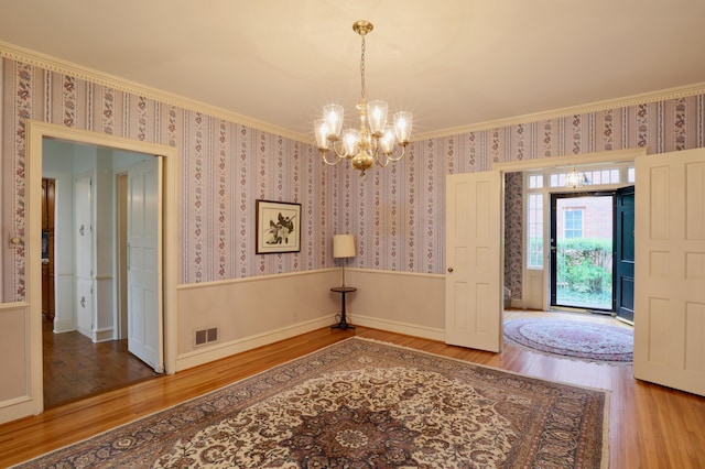 536 E Allen St, Lancaster, OH 43130 - interior space with visible vents, wallpapered walls, wood finished floors, and a notable chandelier