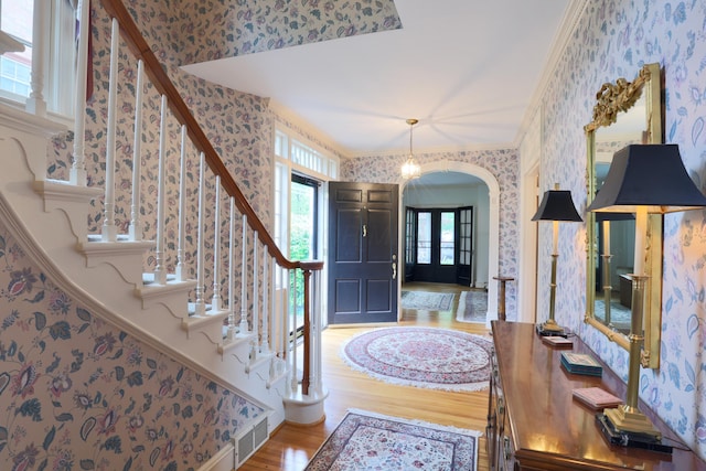 536 E Allen St, Lancaster, OH 43130 - entrance foyer with arched walkways, wood finished floors, stairway, ornamental molding, and wallpapered walls
