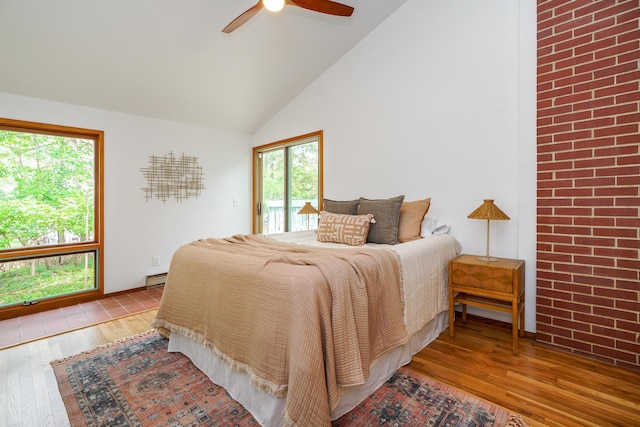 bedroom with ceiling fan, high vaulted ceiling, access to exterior, baseboard heating, and wood finished floors