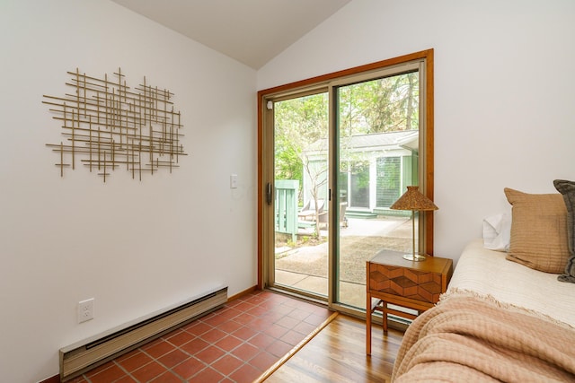 entryway featuring baseboard heating, wood finished floors, and lofted ceiling