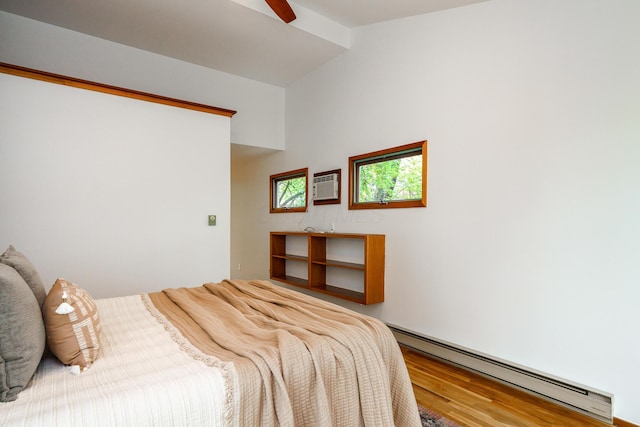 bedroom featuring a wall unit AC, ceiling fan, wood finished floors, baseboard heating, and lofted ceiling