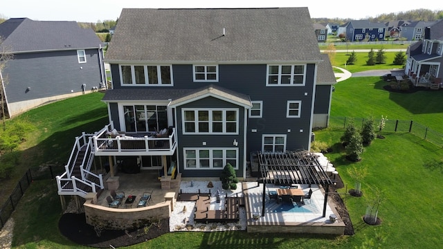 rear view of house featuring a patio area, an outdoor living space, a fenced backyard, roof with shingles, and a deck