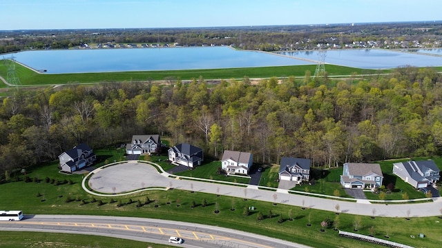 birds eye view of property featuring a residential view, a water view, and a forest view