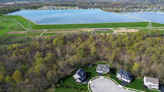 drone / aerial view with a water view and a forest view