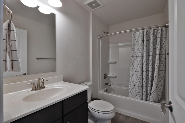 full bath with wood finished floors, toilet, vanity, visible vents, and shower / tub combo with curtain