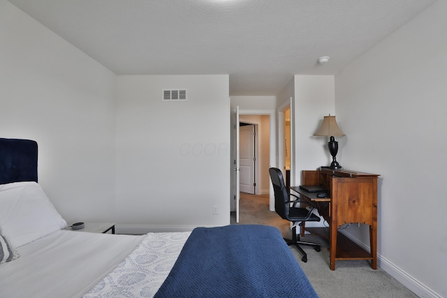 bedroom with visible vents, light carpet, and baseboards
