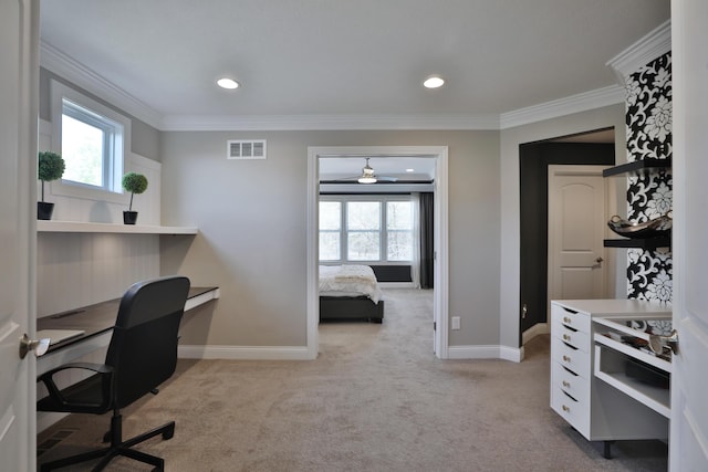 office featuring crown molding, visible vents, a wealth of natural light, and carpet