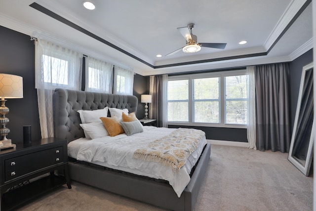 bedroom featuring ornamental molding, recessed lighting, light colored carpet, and a raised ceiling