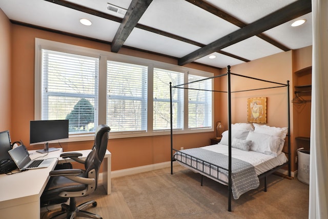 bedroom with beamed ceiling, multiple windows, light carpet, and visible vents