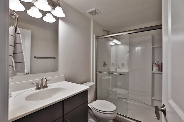 full bath with toilet, visible vents, vanity, and a stall shower