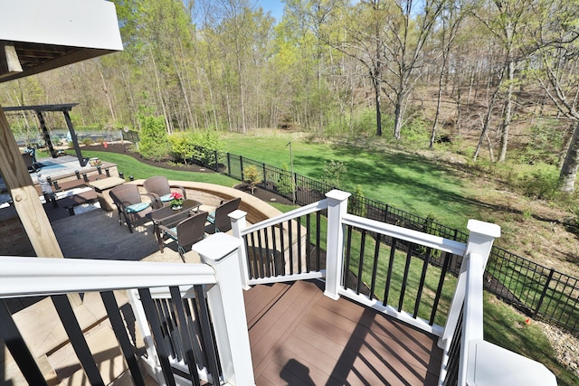deck with an outdoor hangout area, a fenced backyard, and a yard