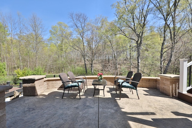 view of patio featuring a forest view