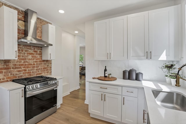 1719 Oak St, Columbus, OH 43205 - kitchen with a sink, light wood-type flooring, backsplash, gas range, and wall chimney range hood