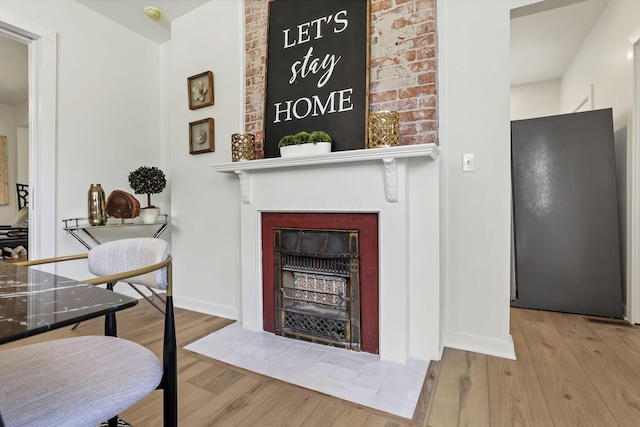 1719 Oak St, Columbus, OH 43205 - living area featuring baseboards, wood finished floors, and a fireplace