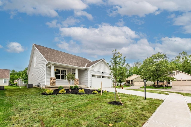 325 Woods Edge Loop, Pataskala, OH 43062 - view of front facade featuring an attached garage, a front yard, driveway, central AC unit, and a shingled roof