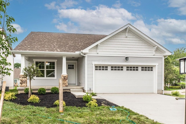 325 Woods Edge Loop, Pataskala, OH 43062 - view of front of property with a garage, concrete driveway, roof with shingles, and a porch
