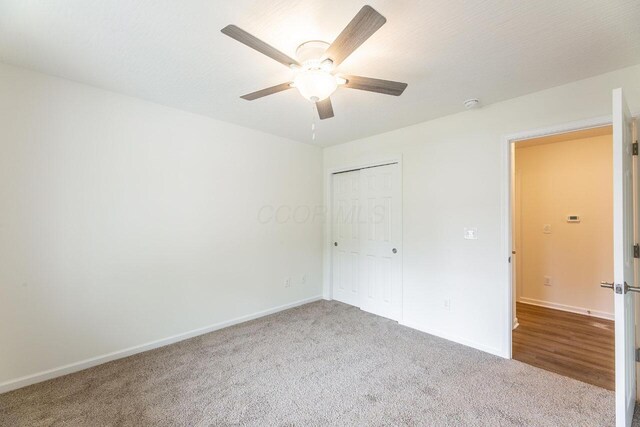 325 Woods Edge Loop, Pataskala, OH 43062 - unfurnished bedroom featuring carpet flooring, baseboards, a closet, and a ceiling fan