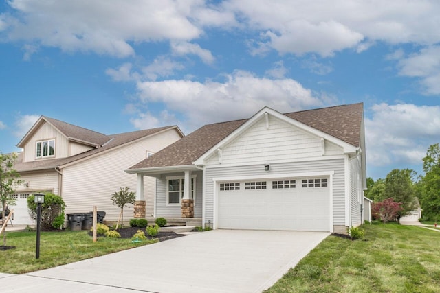 325 Woods Edge Loop, Pataskala, OH 43062 - view of front of property featuring a garage, concrete driveway, a front lawn, and roof with shingles