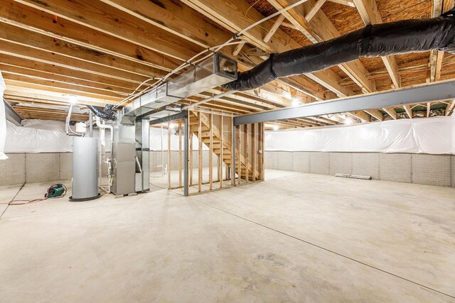 325 Woods Edge Loop, Pataskala, OH 43062 - unfinished below grade area with gas water heater, heating unit, and stairs
