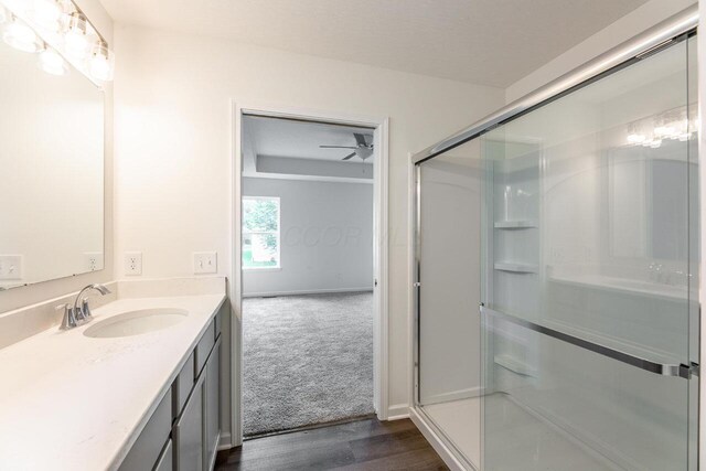 325 Woods Edge Loop, Pataskala, OH 43062 - full bathroom featuring a stall shower, vanity, wood finished floors, and baseboards