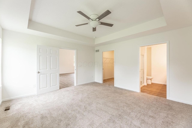 325 Woods Edge Loop, Pataskala, OH 43062 - unfurnished bedroom with carpet, a raised ceiling, and baseboards