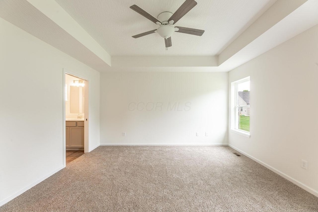 325 Woods Edge Loop, Pataskala, OH 43062 - carpeted empty room with a tray ceiling, ceiling fan, and baseboards