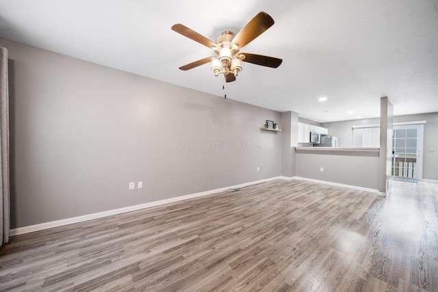 unfurnished living room featuring light wood-style flooring, ceiling fan, baseboards, and recessed lighting