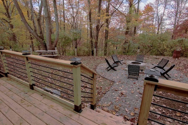 wooden deck featuring an outdoor fire pit