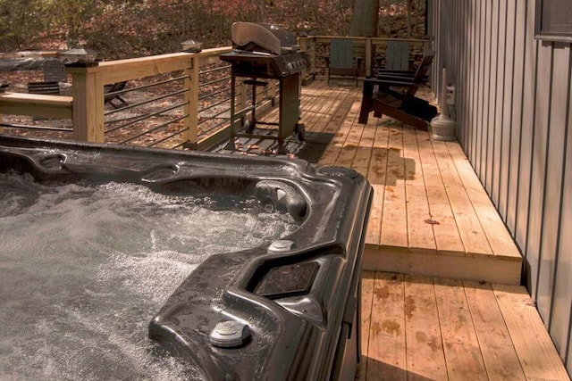 deck featuring grilling area and a hot tub