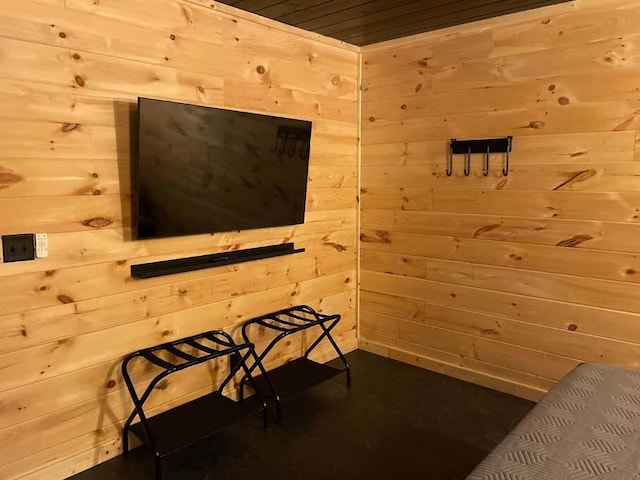 sitting room with wood ceiling and wooden walls