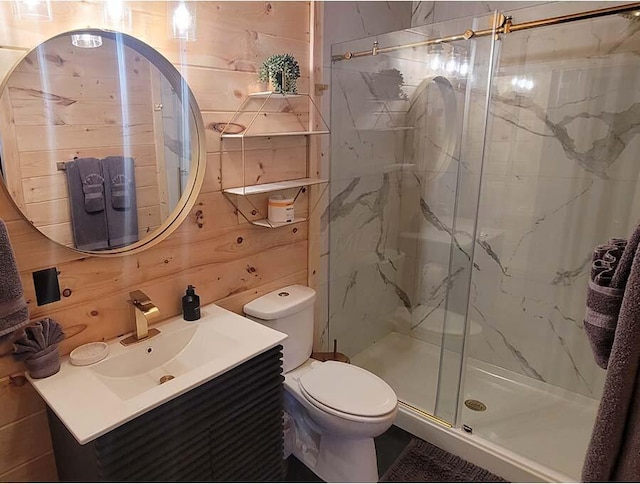 bathroom with toilet, a marble finish shower, and vanity