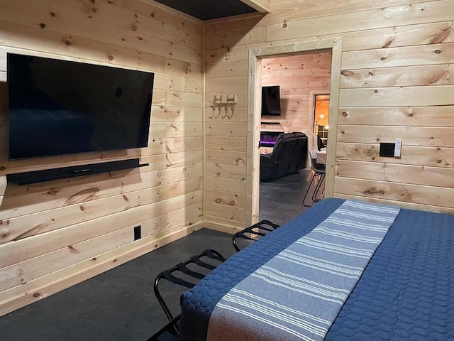 bedroom with concrete flooring and wooden walls